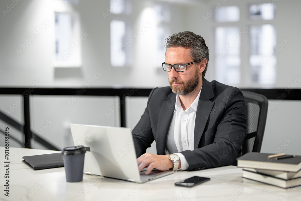 Modern office. Successful caucasian business man in business suit using laptop, working remotely, e-commerce online at office. Finance auditor. Ceo manager employee having business idea. Business Modern office. Successful caucasian business man in business suit using laptop, working remotely, e-commerce online at office. Finance auditor. Ceo manager employee having business idea. Business