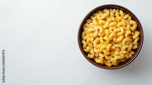 Top view of macaroni in a ceramic bowl on white, with space for text, perfect for food content or recipe blogs