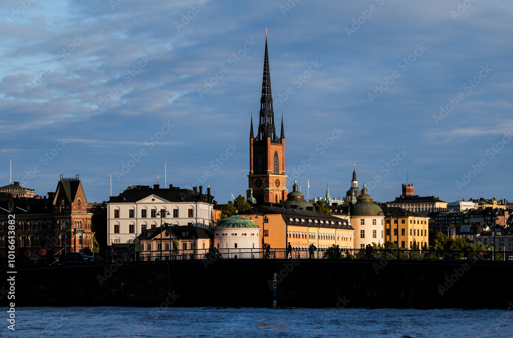 Historic architecture along the waterfront of Stockholm’s Gamla Stan island under a dramatic sky at sunset. Historic architecture against a stunning sunset backdrop with clouds Historic architecture along the waterfront of Stockholm’s Gamla Stan island under a dramatic sky at sunset. Historic architecture against a stunning sunset backdrop with clouds