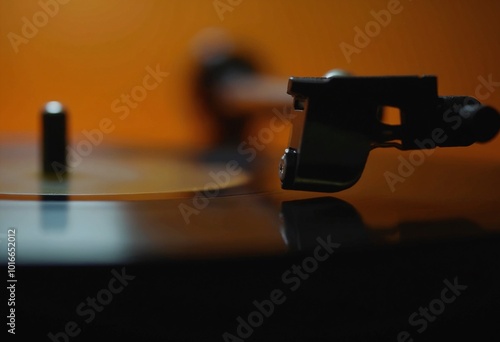 Close-Up Of Vinyl Record Spinning On Turntable With Warm Golden Lighting