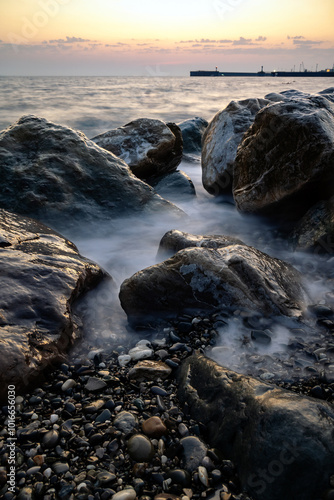 red sunset in the surf on the rocks and splashes