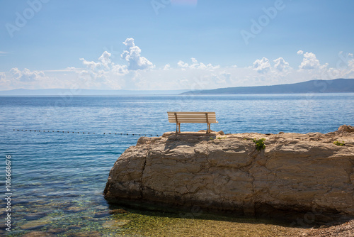 Fototapeta Naklejka Na Ścianę i Meble -  Bench on th erock with beautiful view in Brela, Croatia