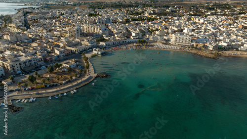 Fototapeta Naklejka Na Ścianę i Meble -  Aerial view Porto Cesareo promenade. It is a small city on the Mediterranean Sea in the province of Lecce in Puglia, Italy. It is a tourist town located on the Ionian coast of the Salento peninsula.