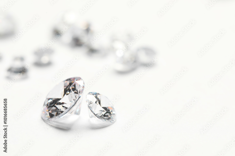 Many beautiful shiny diamonds on white background, closeup. Space for text Many beautiful shiny diamonds on white background, closeup. Space for text