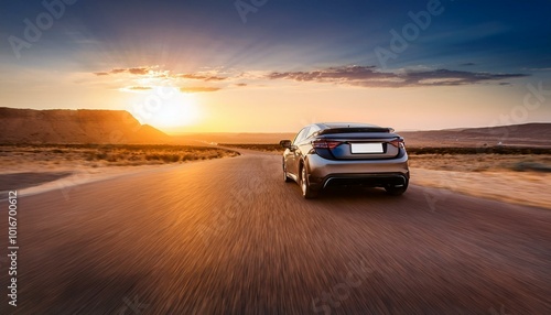 Modern car on the road at sunset in a desert area