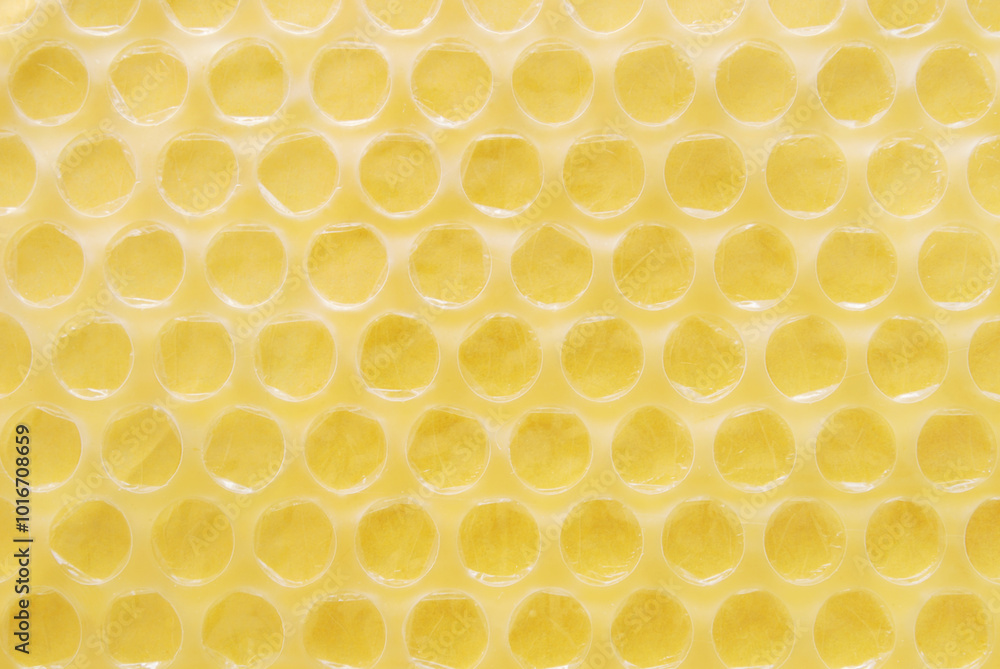 Yellow bubble wrap texture close up as background Yellow bubble wrap texture close up as background