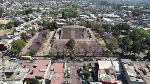 Drone flight over Tenayuca Archaeological Site, Mexico. Pyramid in the middle of the city photo