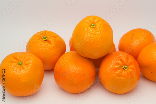 Tangerines and oranges in a gray. Healthy tangerine food concept. A green with oranges, tangerines and other fruits. A green with oranges, tangerines and lifestyle other fruits.