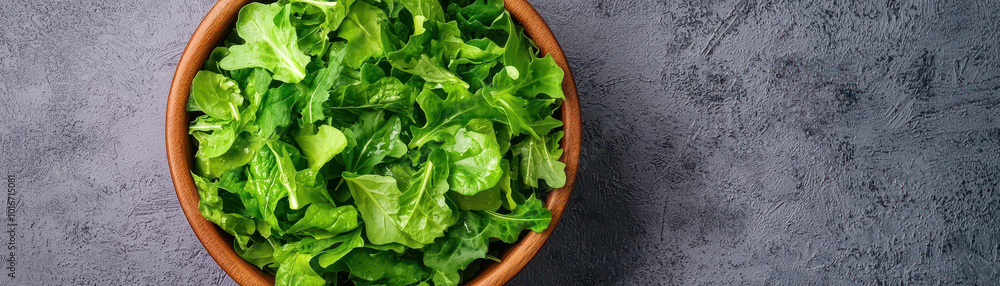 Fresh greens in wooden bowl create vibrant and healthy salad option, perfect for nutritious meals and adding color to your dining table Fresh greens in wooden bowl create vibrant and healthy salad option, perfect for nutritious meals and adding color to your dining table