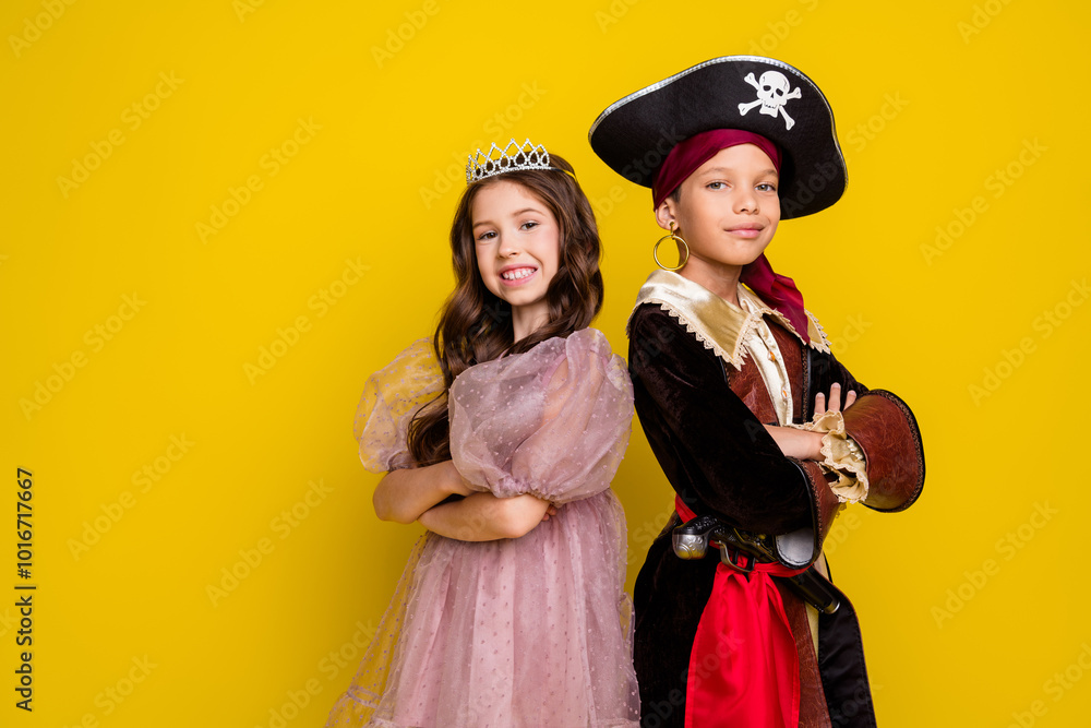 Obraz premium Portrait of two small kids halloween pirate princess costume crossed arms empty space isolated on yellow color background