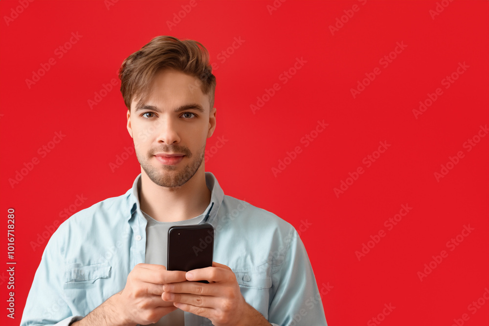 Guy is using smartphone in red on the . man male mobile concept. guy in red with his hands on a smartphone in the . a guy in red with his hands on a smartphone on lifestyle a white. Guy is using smartphone in red on the . man male mobile concept. guy in red with his hands on a smartphone in the . a guy in red with his hands on a smartphone on lifestyle a white.