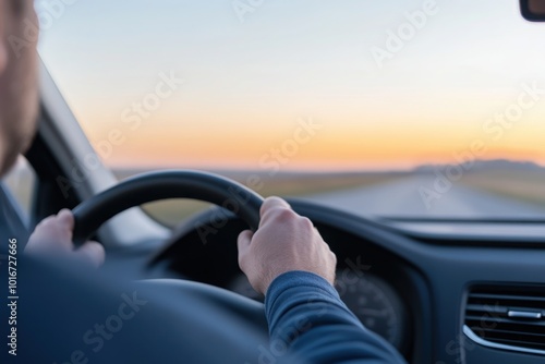 Wallpaper Mural A man is driving a car, holding the steering wheel with both hands. The background shows a rural road and a countryside landscape. Torontodigital.ca