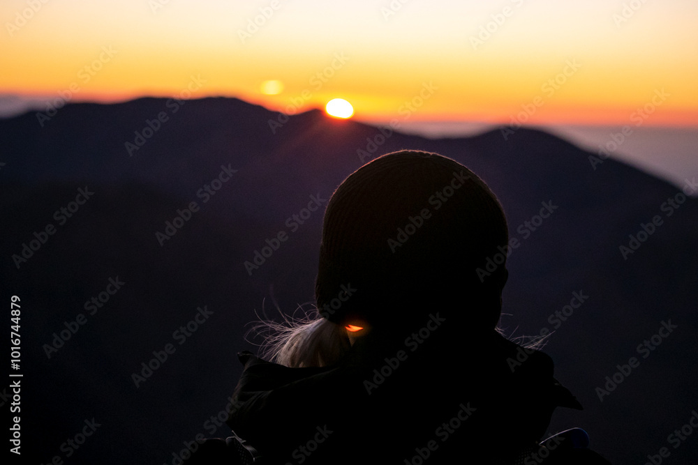 silhouette of a person watching the sunrise silhouette of a person watching the sunrise