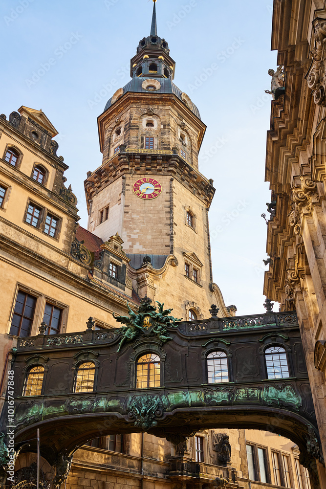 Fototapeta premium Ornate bridge with carvings and statues connects two buildings in Dresden Castle complex. Historical architecture in Germany