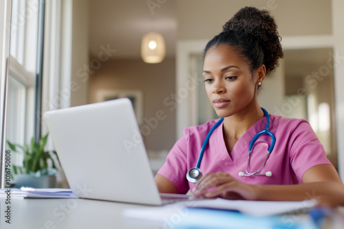 Focused Nurse Working on Laptop in Medical Office