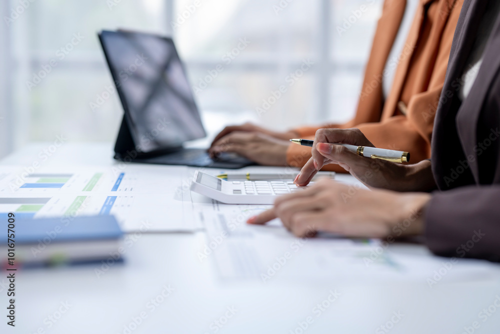 Fototapeta premium Businesswoman calculating financial data using calculator for investment analysis