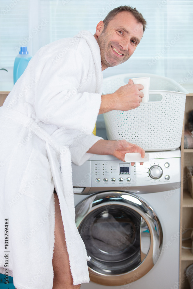 man in bathrobes doing laundry man in bathrobes doing laundry