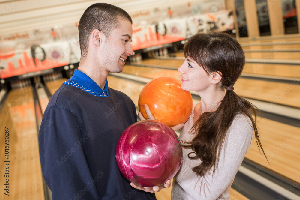 Fototapeta premium couple choosing ball at bowling alley