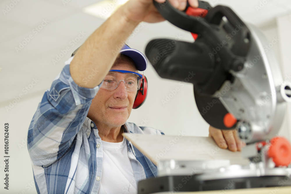 carpenter cutting wooden plank with circular saw carpenter cutting wooden plank with circular saw