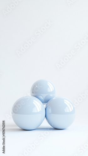 Glossy blue spheres with reflective surfaces arranged in triangular formation on white background create serene and modern aesthetic. Vertical 4K smartphone wallpaper