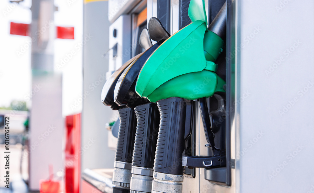 Close up of gas station Nozzles. Refueling pistols on  a pistole holder.  Vehicle gasoline refill process. Selective focus