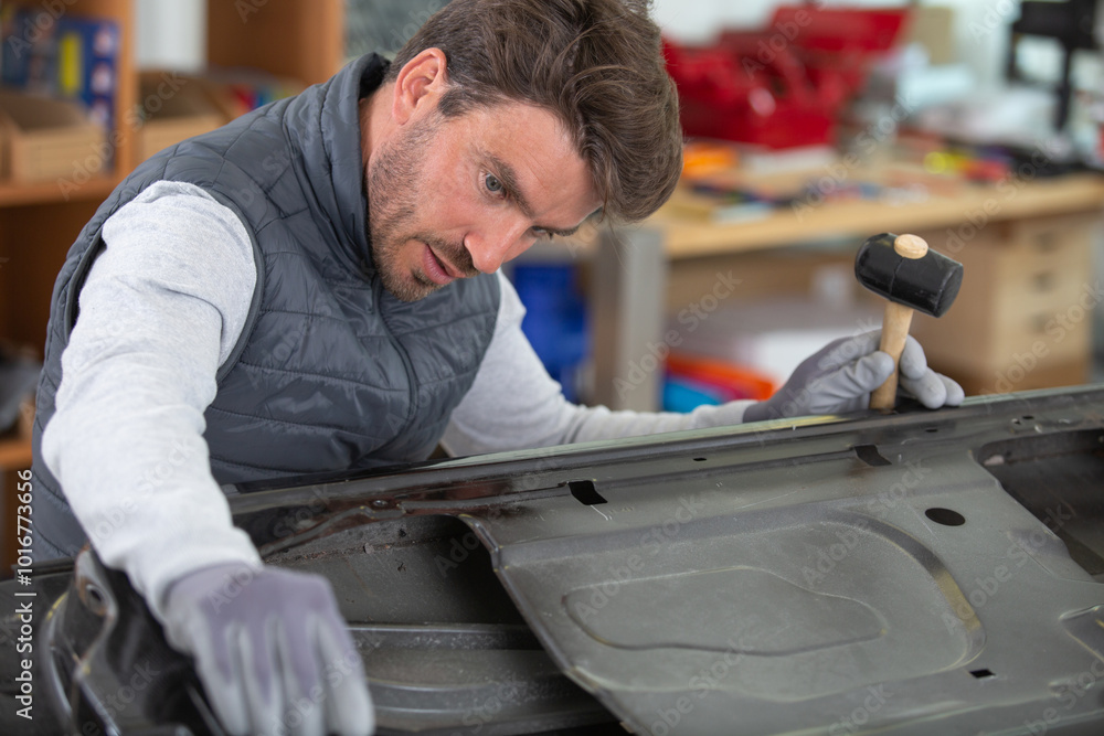 mechanic in blue uniform at a repair garage