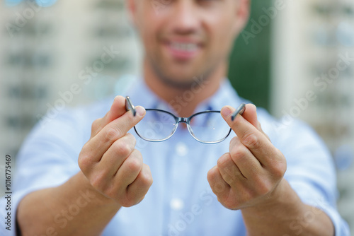 man with glasses showing something