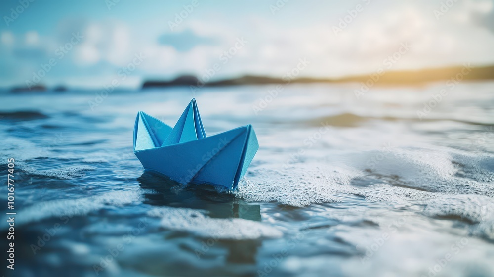 Obraz premium Blue Paper Boat Floating on Ocean Waves