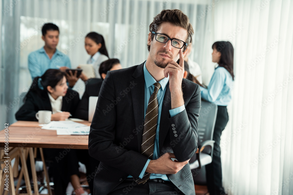 Portrait of happy businessman looking at camera with motion blur background of business people movement in dynamic business meeting. Habiliment Portrait of happy businessman looking at camera with motion blur background of business people movement in dynamic business meeting. Habiliment
