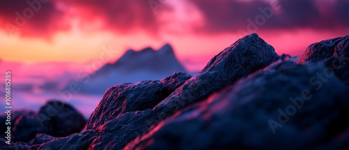  A cluster of rocks perched atop a mountain beneath a cloud-studded sky in shades of pink, orange, and purple photo