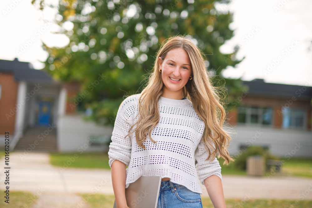 Young girl high school or college student She is on her way to class near university building