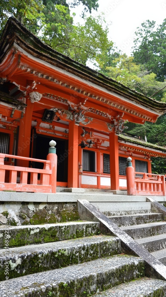 A peaceful shrine nestled in the forest, surrounded by lush greenery and ancient trees A peaceful shrine nestled in the forest, surrounded by lush greenery and ancient trees