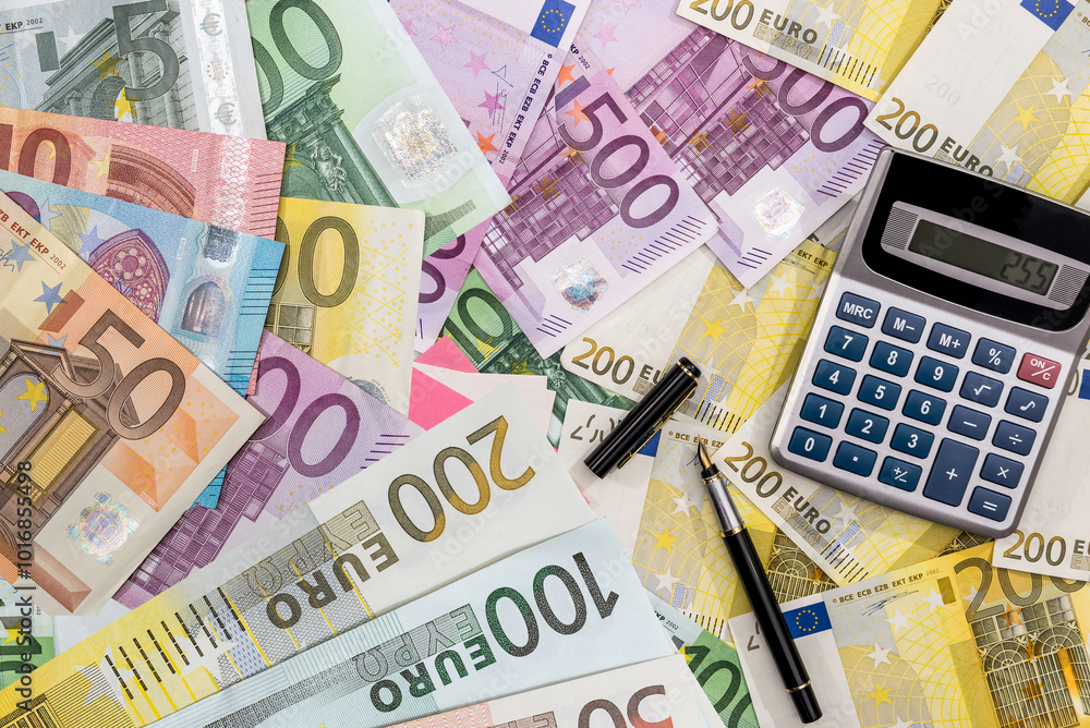 Euro paper money with calculator on desk Euro paper money with calculator on desk