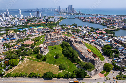 Beautiful aerial drone view of the San Felipe Castle, with the huge Cartagena Flag waving and the city in the the background photo