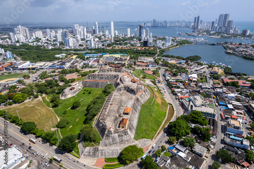 Beautiful aerial drone view of the San Felipe Castle, with the huge Cartagena Flag waving and the city in the the background photo