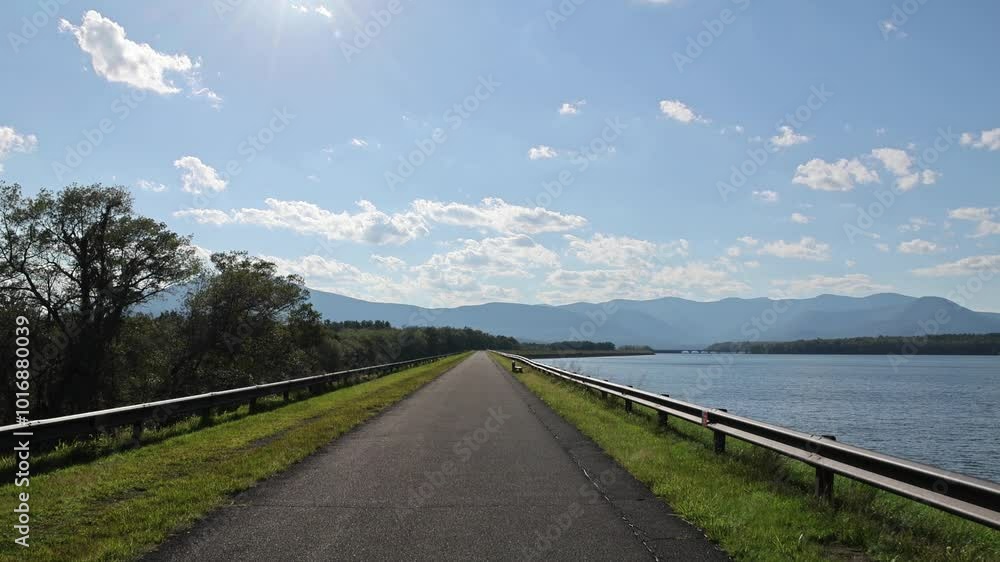 riding along the bike trail (ashokan reservoir) with catskill mountains in the background (lake, pond, creek) blue water trees summer riding along the bike trail (ashokan reservoir) with catskill mountains in the background (lake, pond, creek) blue water trees summer