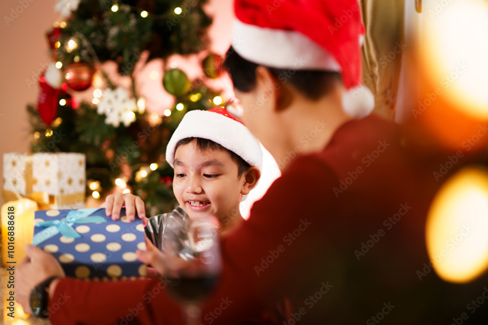 Lovely Asian family father and son are celebrating Christmas and New Year dinner party together. Lovely Asian family father and son are celebrating Christmas and New Year dinner party together.