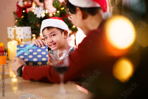 Lovely Asian family father and son are celebrating Christmas and New Year dinner party together.