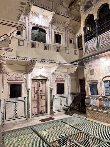 Intricate Courtyard: A serene haven in the heart of a traditional Indian home. Ornate doorways, intricate tilework, and soft lighting create a sense of peace and tranquility.   photo