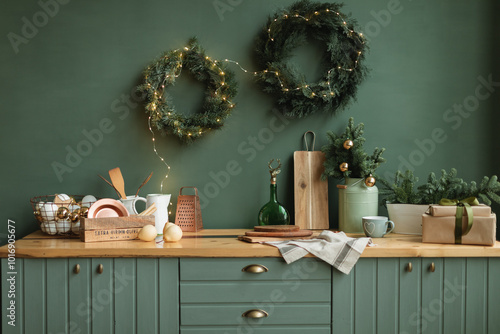 Rustic kitchen decorated for Christmas with fir wreaths, fir decorations, Christmas baubles and illuminated fairy lights photo