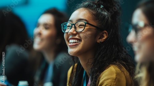 Young women laugh at a conference with their friends.