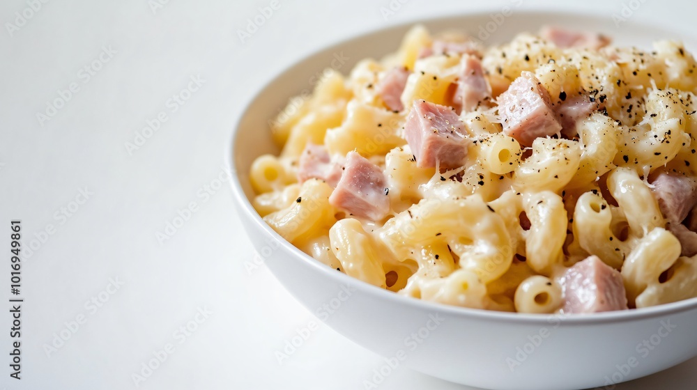 A serving of French coquillette au jambon, macaroni with ham and cheese, isolated on a clean background A serving of French coquillette au jambon, macaroni with ham and cheese, isolated on a clean background