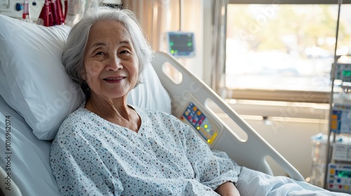 A smiling elderly woman in a hospital bed, portraying a sense of comfort and resilience during her recovery. photo