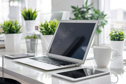 Wallpaper Mural Modern workspace with laptop and tech gadgets amidst greenery Torontodigital.ca
