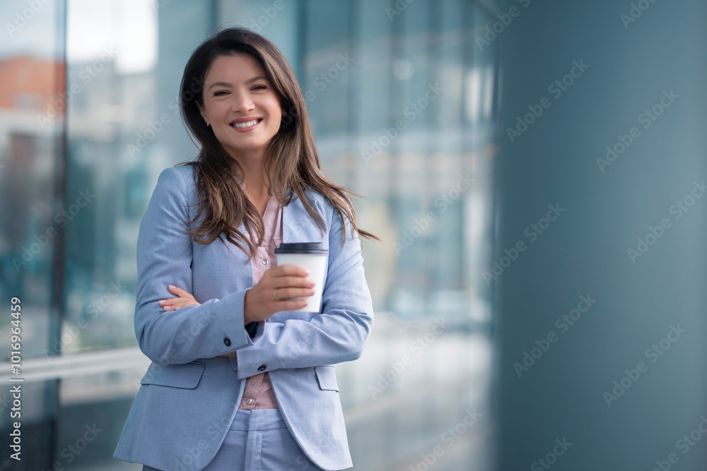 Portrait of happy businesswoman walking outdoor and holding cup of coffee Portrait of happy businesswoman walking outdoor and holding cup of coffee