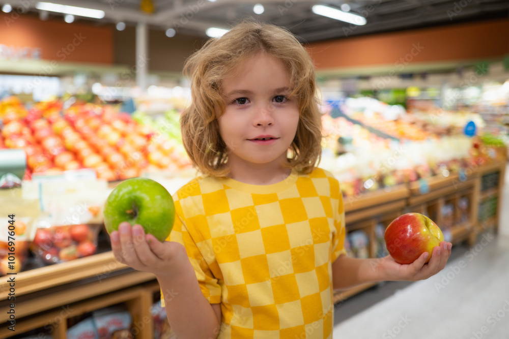 Child hold apple fruits at grocery store. Child choosing fruits and vegetables during shopping at vegetable supermarket. Child hold apple fruits at grocery store. Child choosing fruits and vegetables during shopping at vegetable supermarket.
