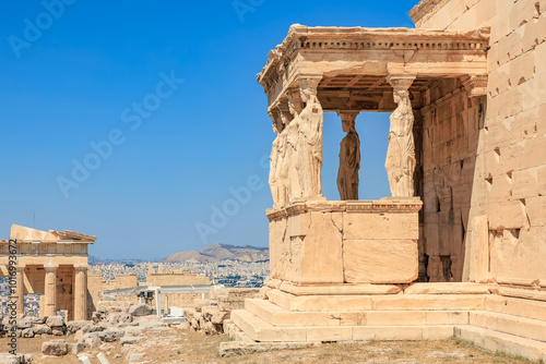 A view of a building with a balcony and a statue of a woman on it, Acropolis in Athens