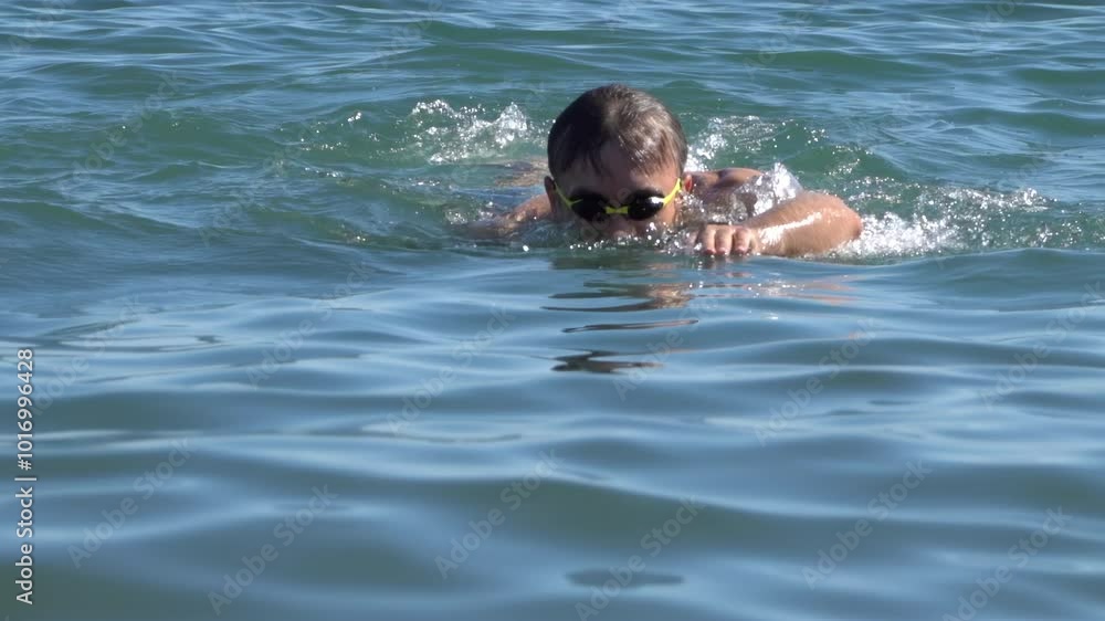 Man swimming in the sea on a sunny day Man swimming in the sea on a sunny day