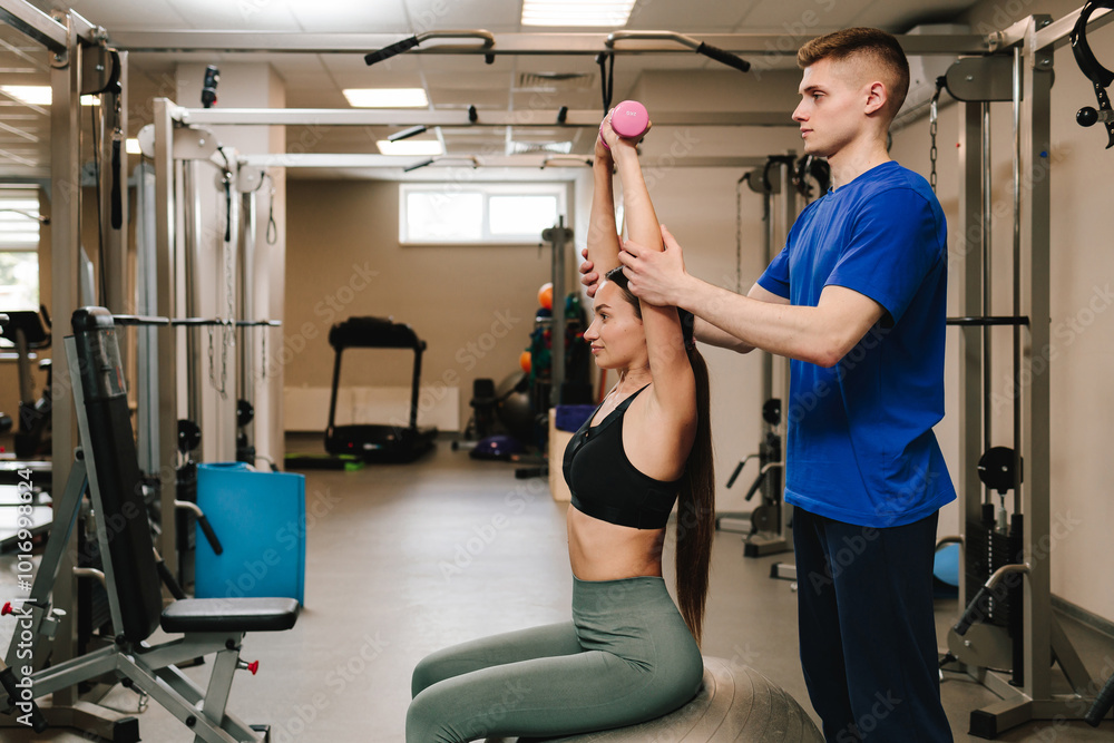 Doing kinesiology therapy to cardiovascular and pulmonary systems. Young woman is doing supervised therapeutic gymnastics to optimize physical performance. Doing kinesiology therapy to cardiovascular and pulmonary systems. Young woman is doing supervised therapeutic gymnastics to optimize physical performance.
