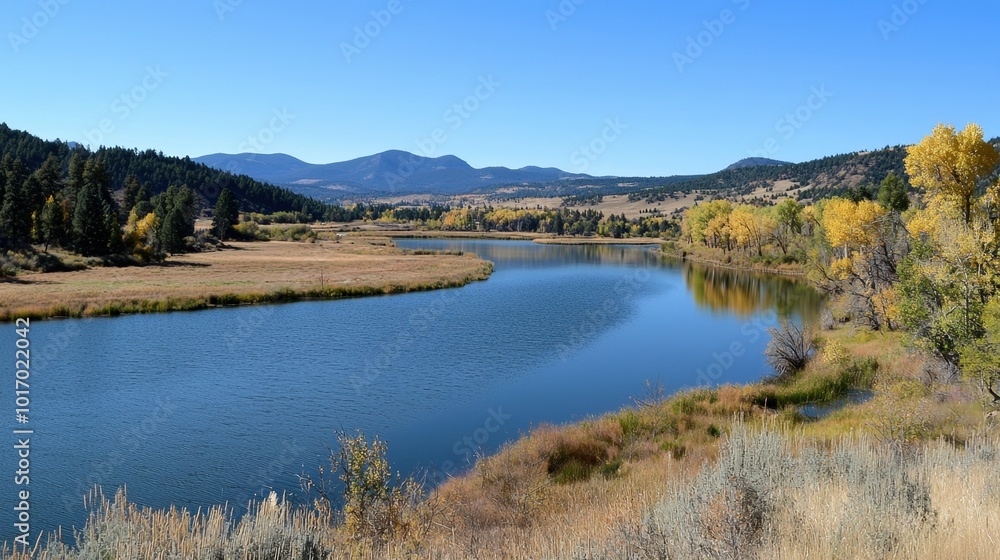 Tranquil river winding through vibrant autumn landscape in the mountains Tranquil river winding through vibrant autumn landscape in the mountains